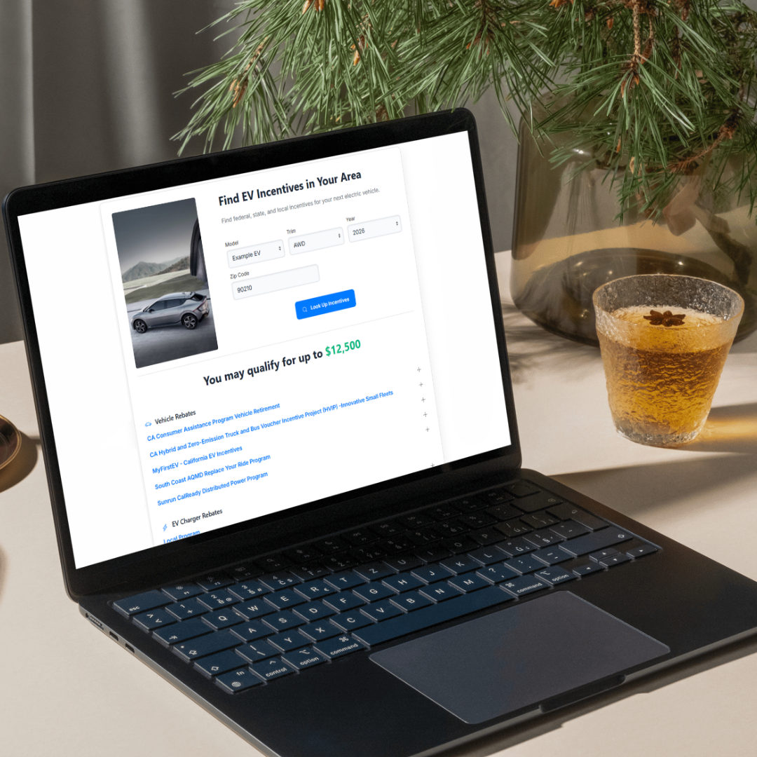 Electric Vehicle Rebate Finder displayed on a laptop with vehicle-specific incentive results