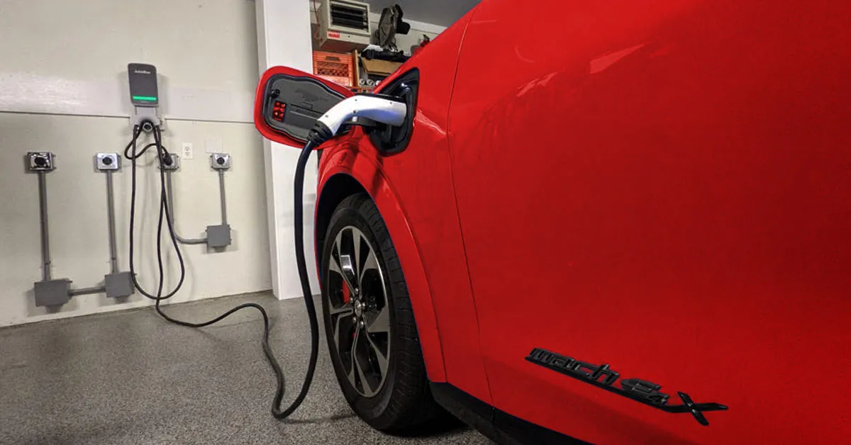 red electric car charging in a garage