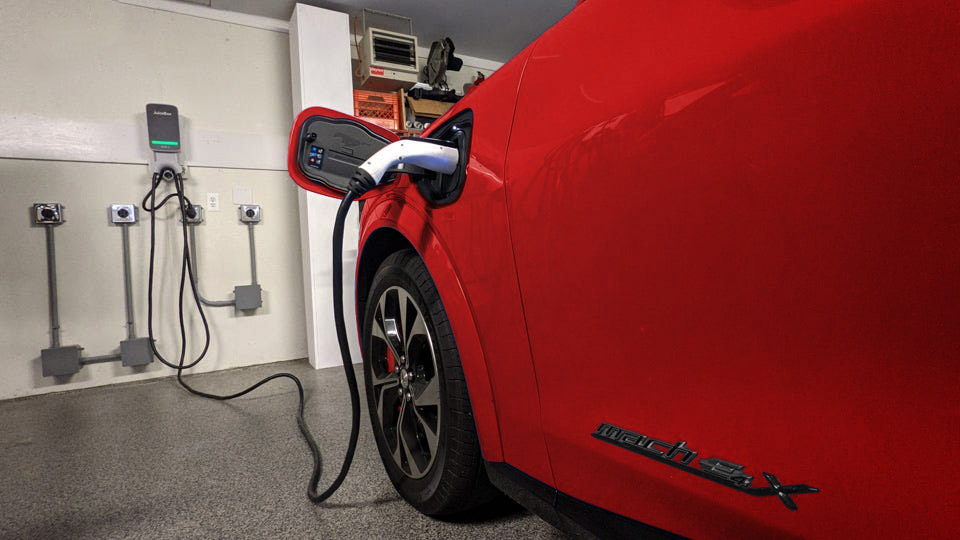 red electric car charging in garage